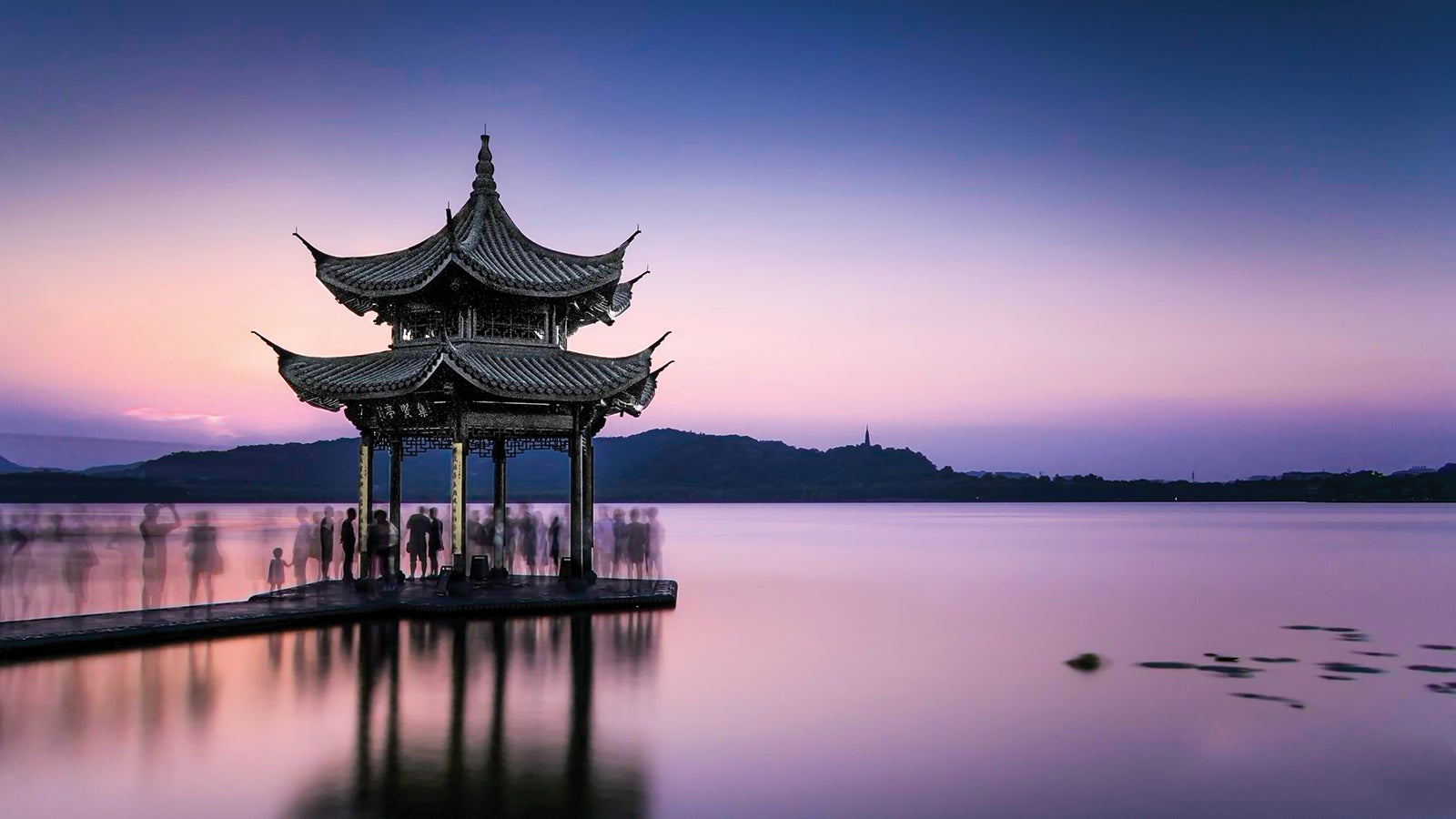 East Asian pagoda on the water at sunset