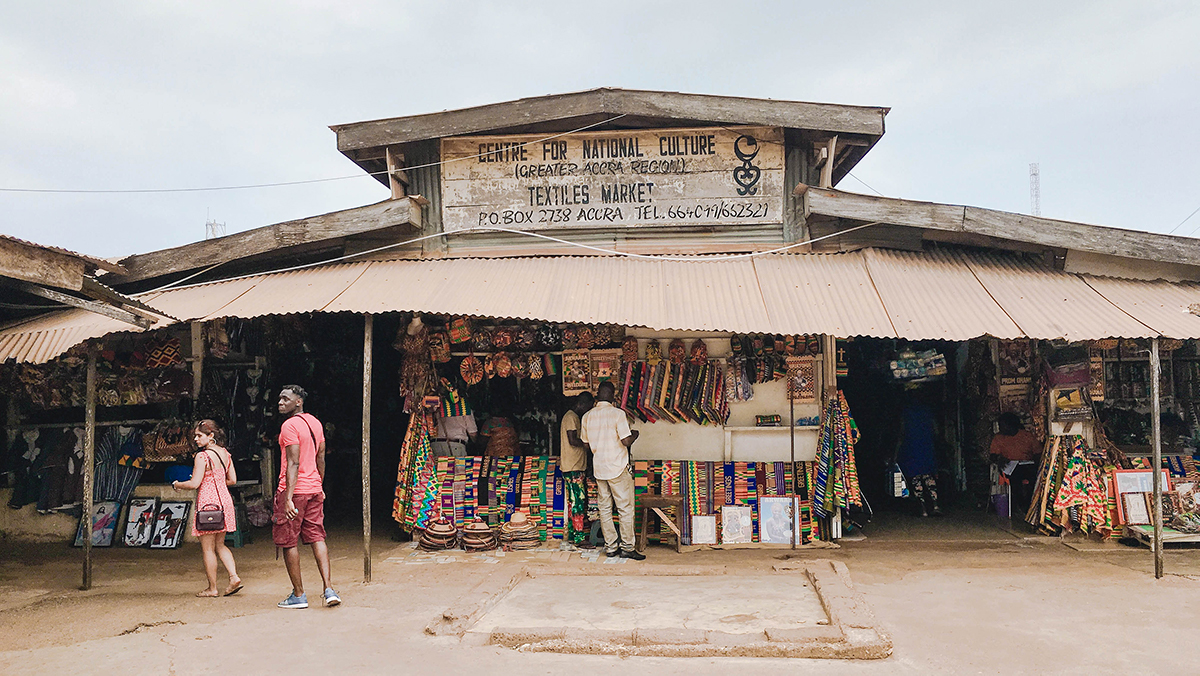 ghanaians walk through a textile market in Ghana